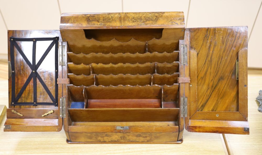 A Victorian figured walnut table stationery cabinet